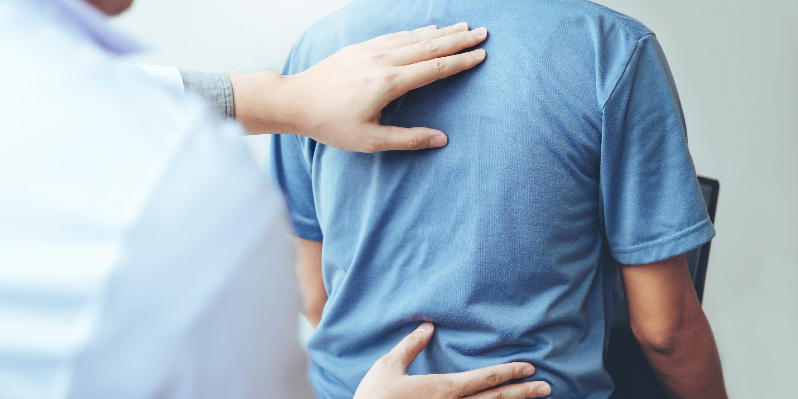 Doctor consulting patient with back problems